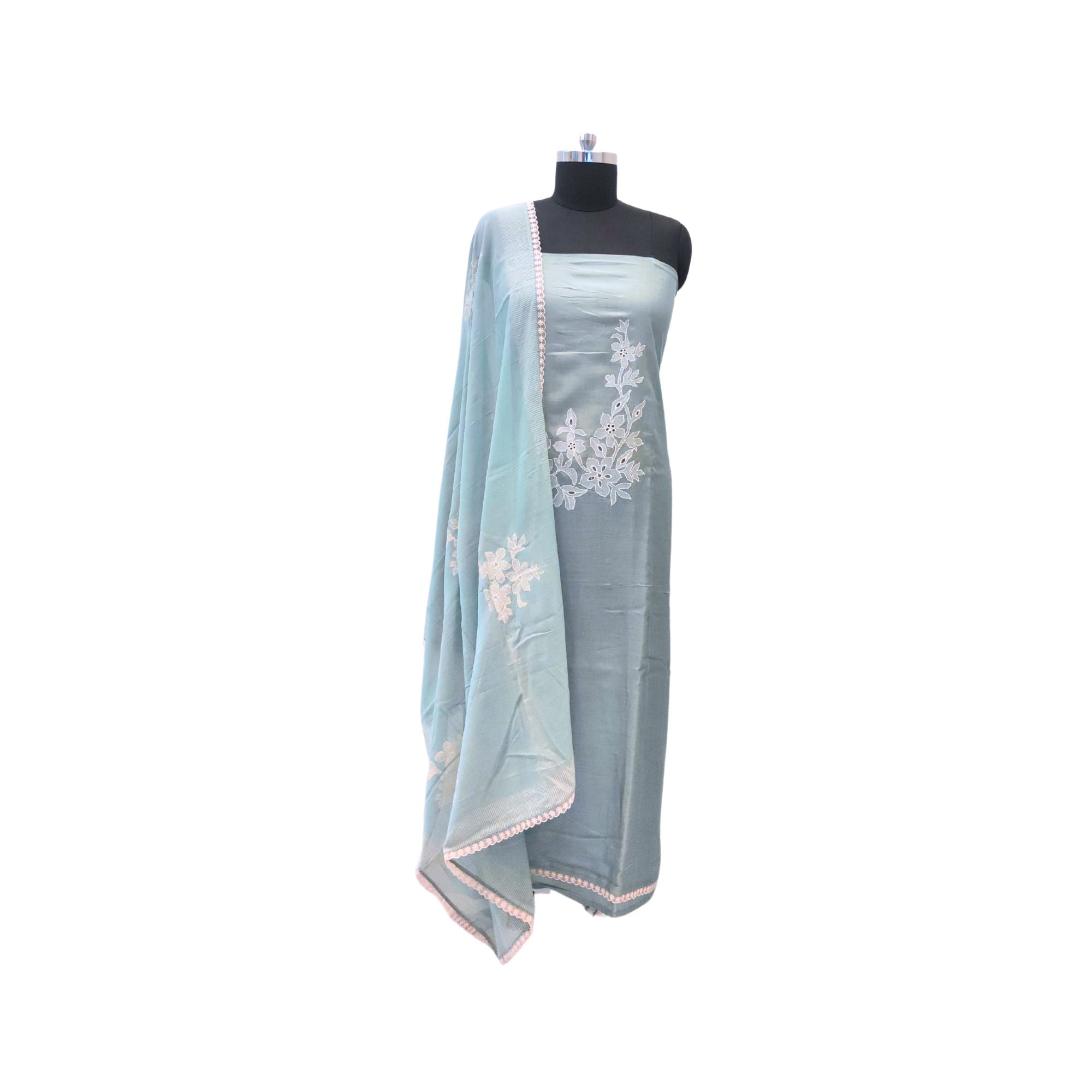 Muslin suit with intricate machine embroidery, paired with a muslin dupatta featuring delicate thread work lace — elegant and graceful.