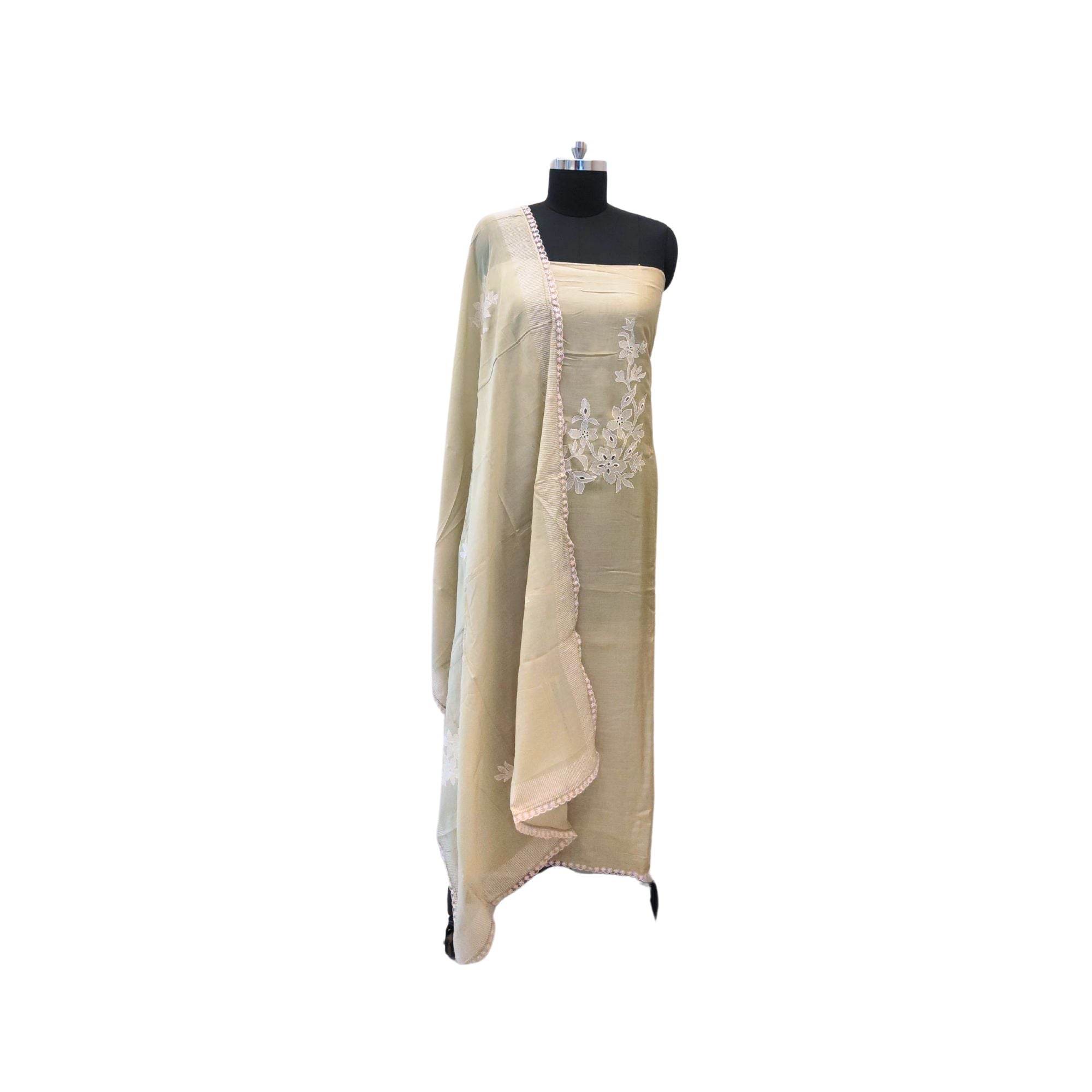 Muslin suit with intricate machine embroidery, paired with a muslin dupatta featuring delicate thread work lace — elegant and graceful.