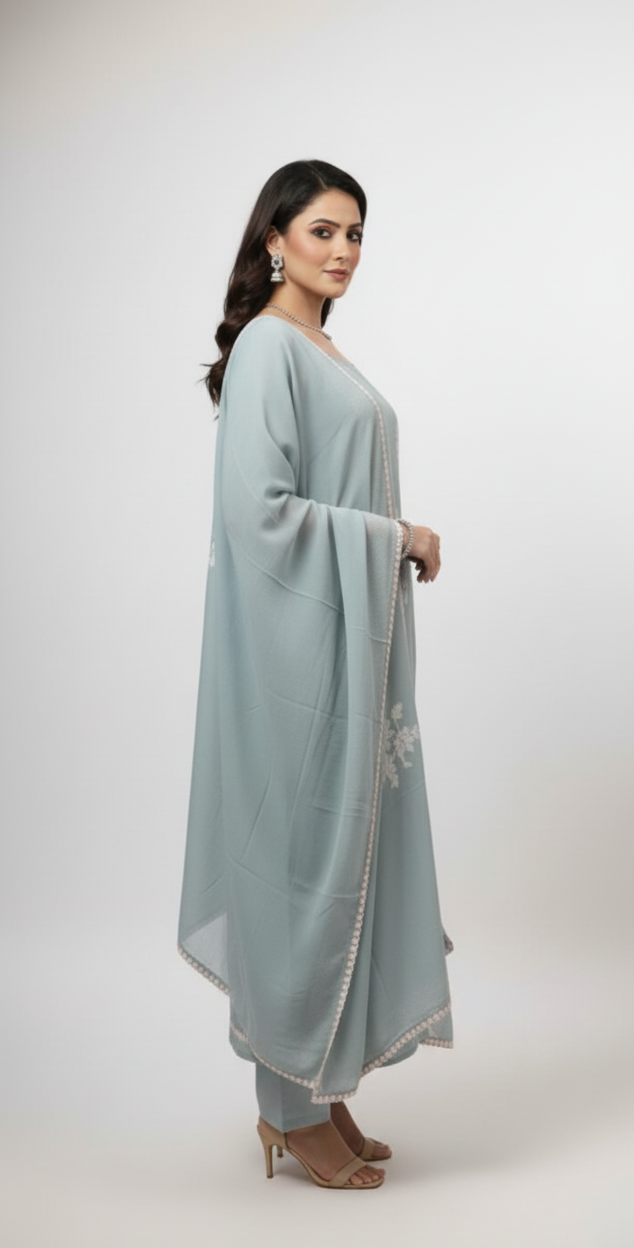 Muslin suit with intricate machine embroidery, paired with a muslin dupatta featuring delicate thread work lace — elegant and graceful.