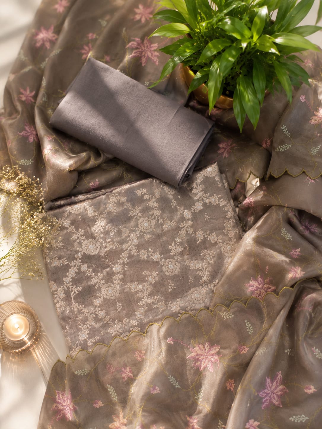 Opulent brocade suit adorned with jal patterns, paired with a delicately embroidered tissue dupatta.